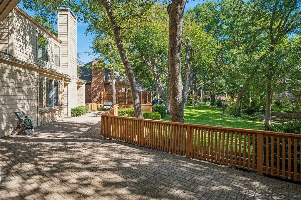 2926 N Saint Andrews Drive, Richardson, TX 75082 Another view of the spacious paved wrap-around deck looking out to the creek lot backyard with lots of trees.