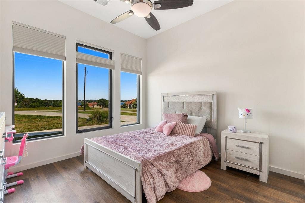 211 Hunter Pass, Waxahachie, TX 75165 High ceilings featuring a central ceiling fan, expansive triple-pane windows, and wood-finish flooring