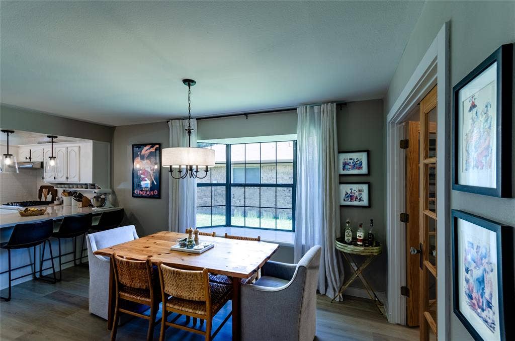 Open concept dining area with wood-finish flooring