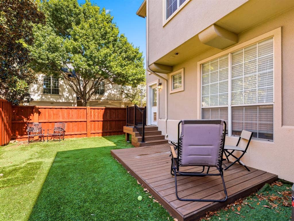 14567 Juliard Lane, Addison, TX 75001 Private backyard featuring a wooden deck with stairs, synthetic turf lawn, and perimeter wood fencing