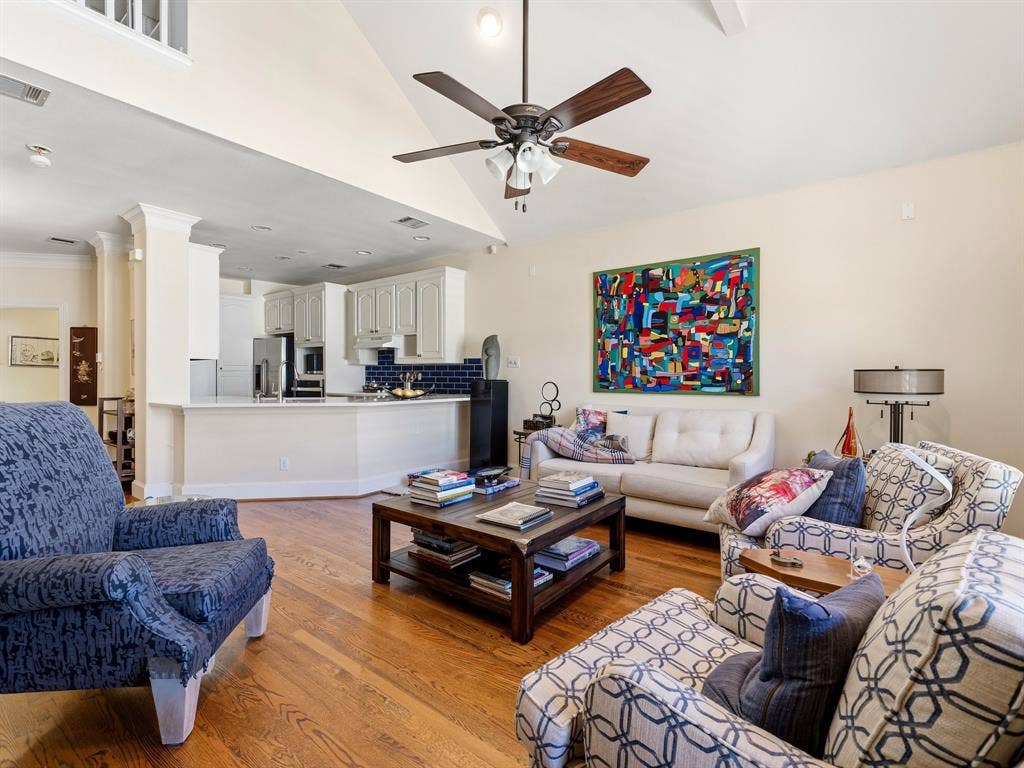 14567 Juliard Lane, Addison, TX 75001 Vaulted ceilings with recessed lighting, wood-finish flooring, ceiling fan, and kitchen featuring cabinetry and a subway tile backsplash