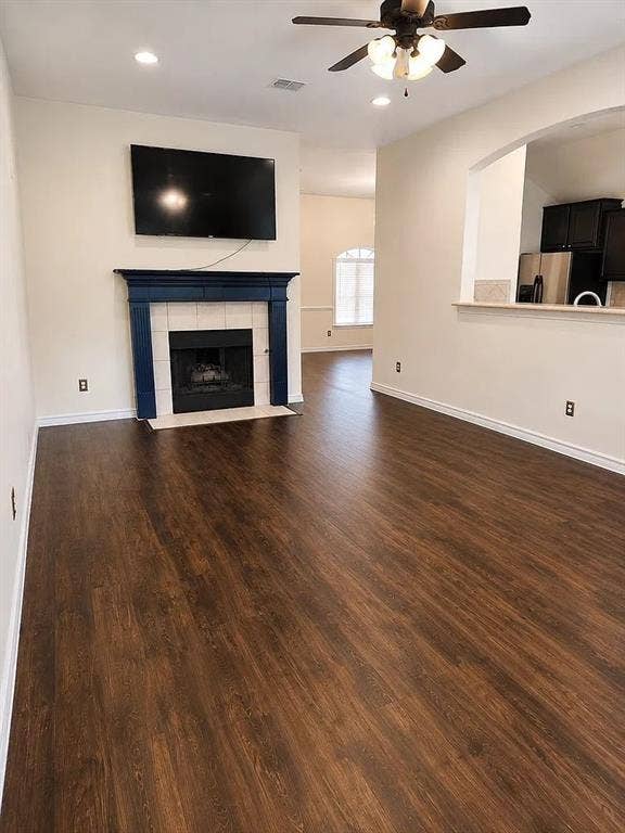 1207 Fox Trail Drive, Allen, TX 75002 Living area featuring dark wood-finish flooring, recessed lighting, and a fireplace with a mantel and tiled surround