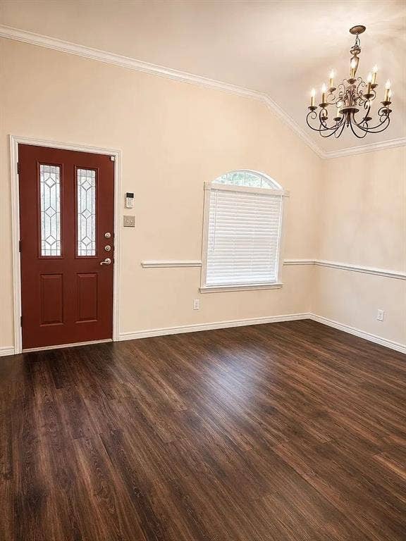 1207 Fox Trail Drive, Allen, TX 75002 Vaulted ceiling with an arched window, wood-finish flooring, decorative chair rail molding, and a multi-arm chandelier