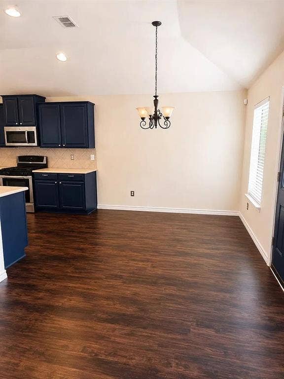 1207 Fox Trail Drive, Allen, TX 75002 Kitchen featuring dark blue cabinetry, wood-finish flooring, vaulted ceilings, and a decorative wrought-iron chandelier