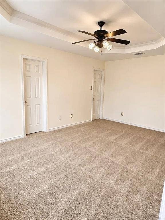 1207 Fox Trail Drive, Allen, TX 75002 Tray ceiling with central light fixture and ceiling fan, wall-to-wall carpeting, and two interior six-panel doors