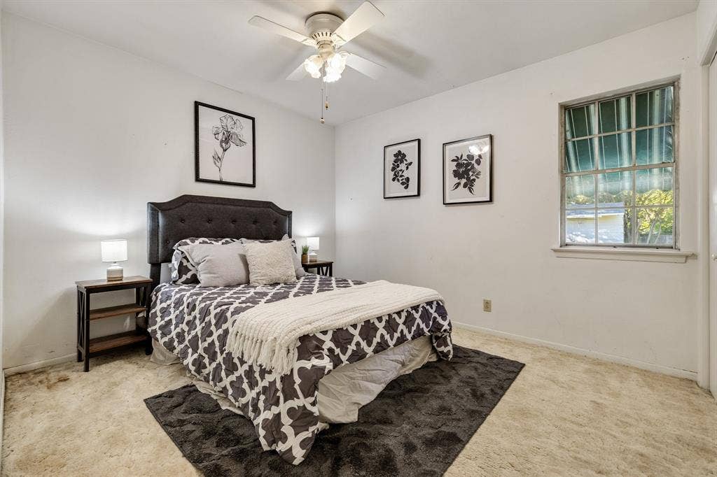 3209 Sheffield Street, Irving, TX 75062 Room featuring neutral wall finishes, carpeted flooring, a ceiling fan with integrated lighting, and a multi-pane window with an exterior metal awning