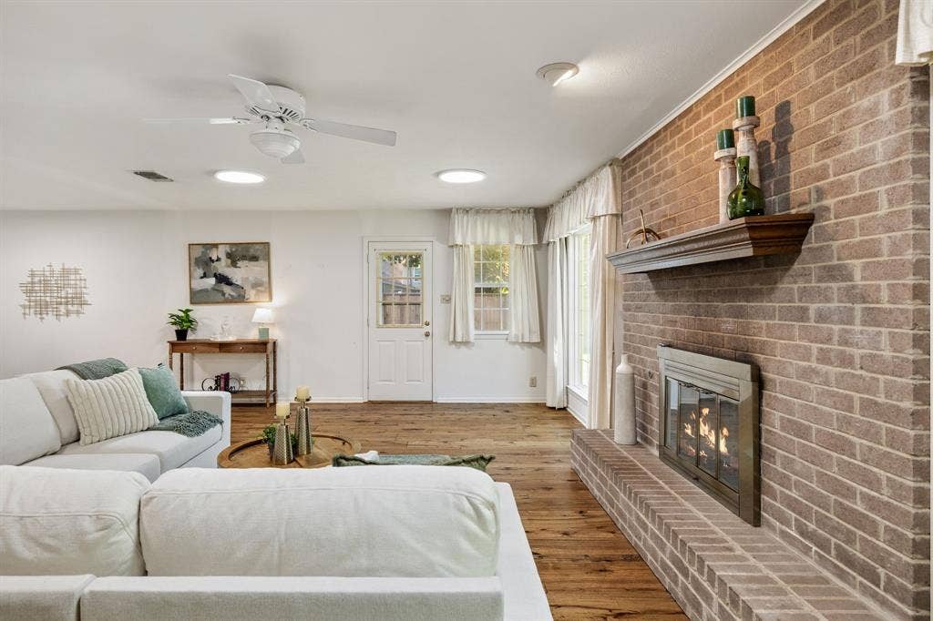 3209 Sheffield Street, Irving, TX 75062 Living space featuring wood-finish flooring, a floor-to-ceiling brick fireplace with a wood mantel, a ceiling fan, and recessed lighting