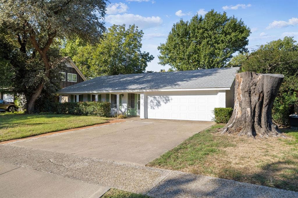 3209 Sheffield Street, Irving, TX 75062 Single-story residence featuring a painted brick exterior, covered front porch, and an attached two-car garage