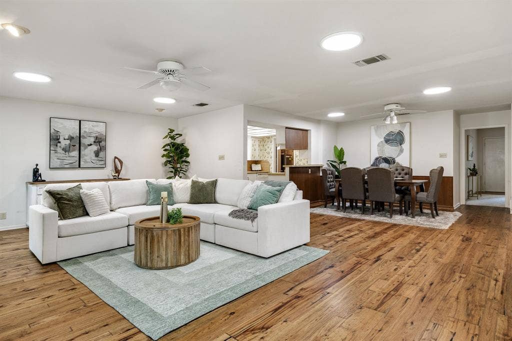3209 Sheffield Street, Irving, TX 75062 Open-concept floor plan featuring wood-finish flooring, recessed lighting, ceiling fans, and a pass-through opening