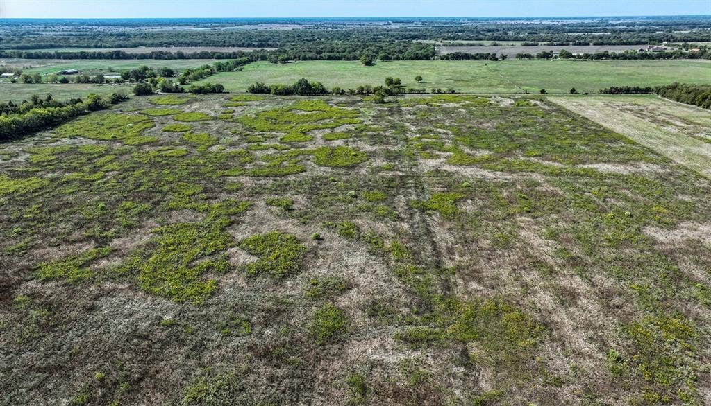 0 County Road 4604, Commerce, TX 75428 Expansive acreage featuring open meadow terrain, native vegetation, and mature tree lines