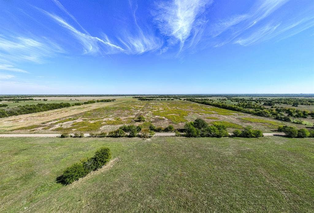 0 County Road 4604, Commerce, TX 75428 Expansive acreage featuring cleared pasture land, clusters of mature trees, and direct road access