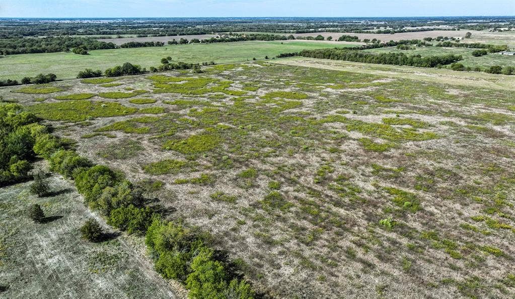 0 County Road 4604, Commerce, TX 75428 Expansive acreage featuring cleared terrain and mature tree line borders