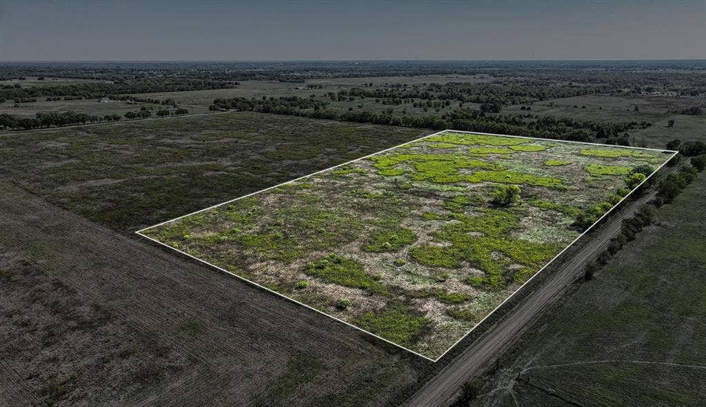 0 County Road 4604, Commerce, TX 75428 Expansive acreage featuring cleared topography, native vegetation, and frontage on a gravel road
