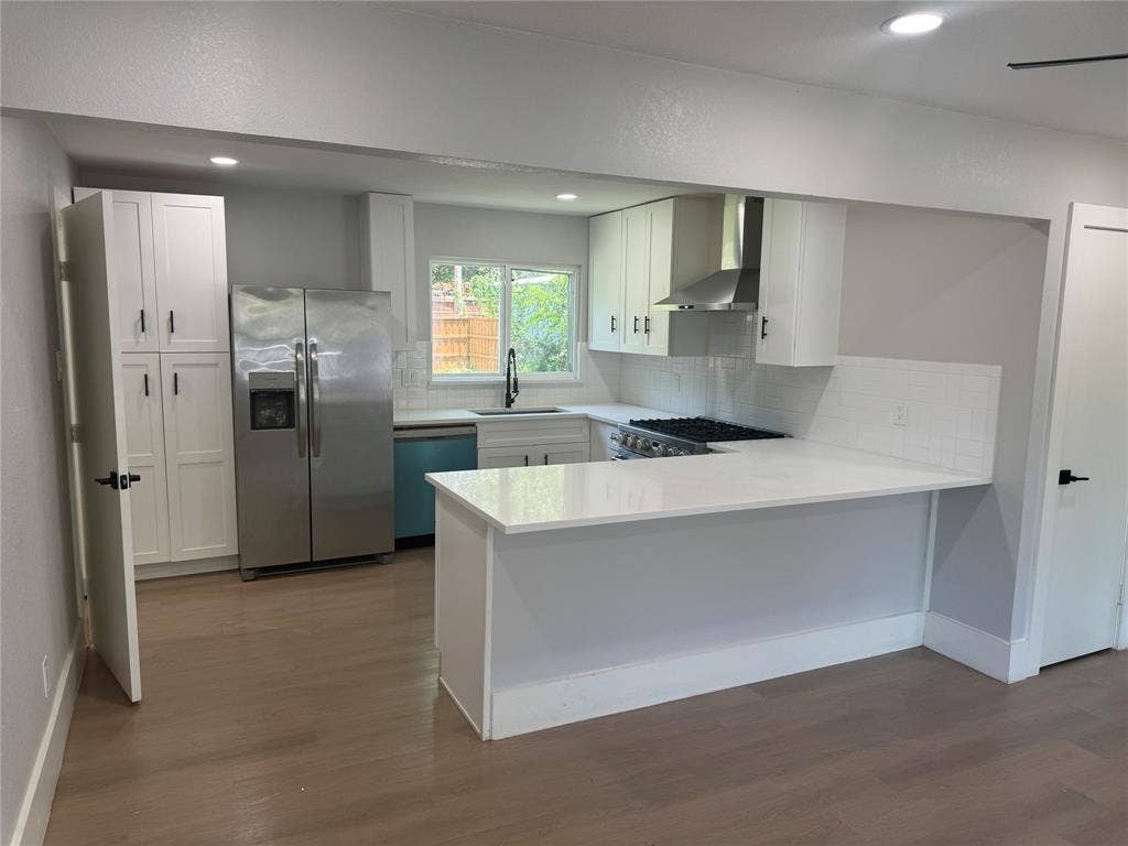 1123 Hansboro Avenue, Dallas, TX 75224 Kitchen featuring white shaker-style cabinetry, quartz countertops, stainless steel appliances, a subway tile backsplash, and wood-finish flooring