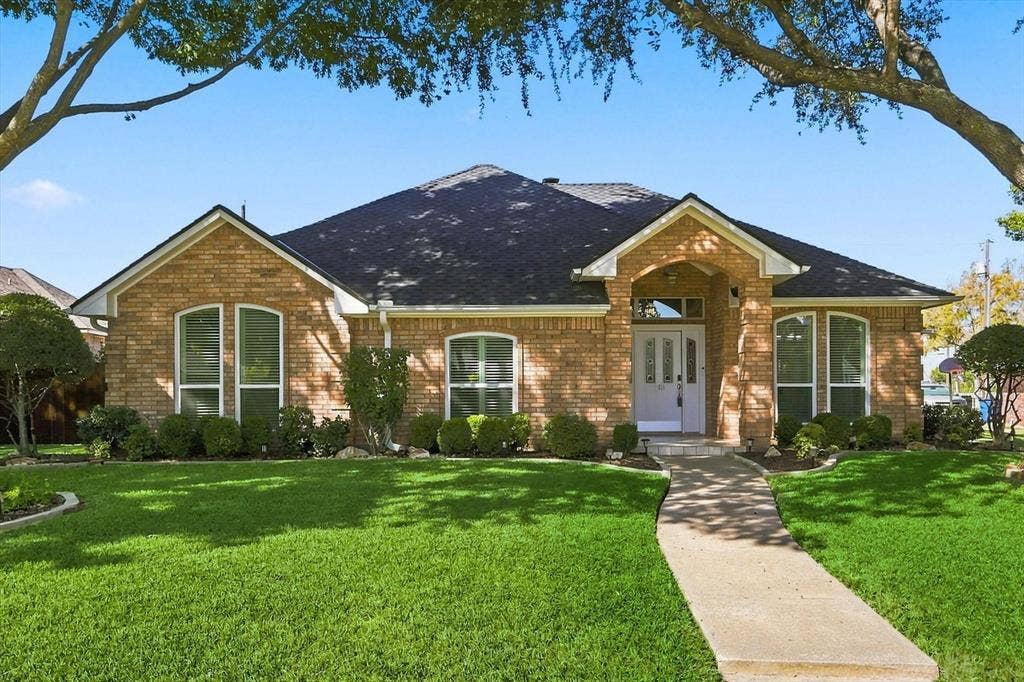 210 Santa Fe Trail, Waxahachie, TX 75165 Single-story brick exterior featuring a multi-gabled roofline, arched windows, and a covered entryway with a decorative front door