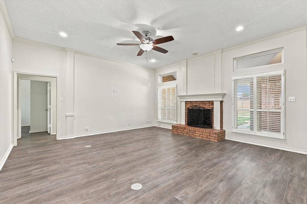 210 Santa Fe Trail, Waxahachie, TX 75165 Living area featuring wood-finish flooring, recessed lighting, a brick fireplace with a mantle, and tall windows with plantation shutters