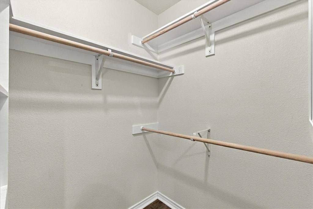 210 Santa Fe Trail, Waxahachie, TX 75165 Walk-in closet featuring multi-level wood hanging rods and built-in shelving