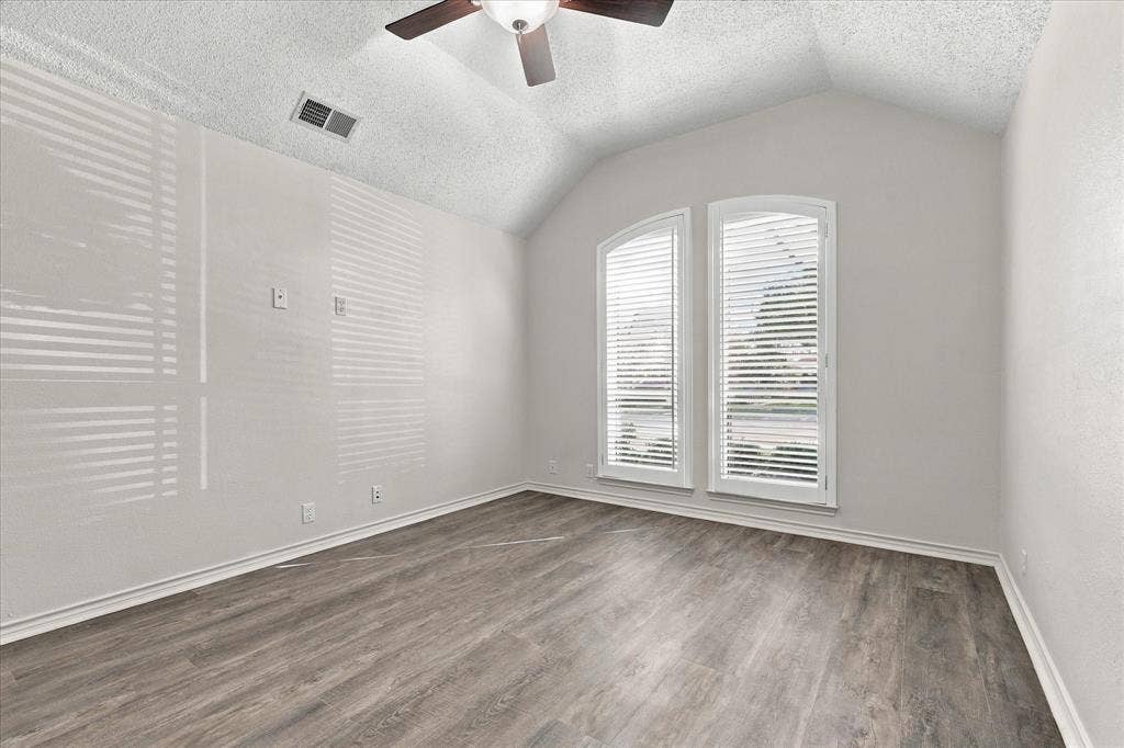 210 Santa Fe Trail, Waxahachie, TX 75165 Room featuring vaulted ceilings, wood-finish flooring, and arched windows