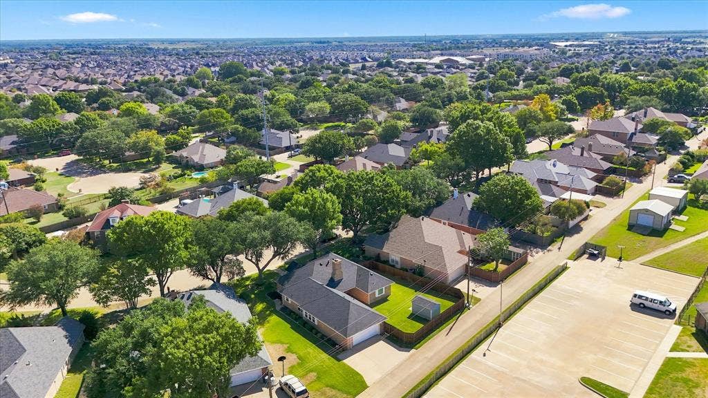 210 Santa Fe Trail, Waxahachie, TX 75165 Aerial perspective featuring a brick exterior residence, gabled roofline, concrete driveway, and a fenced backyard