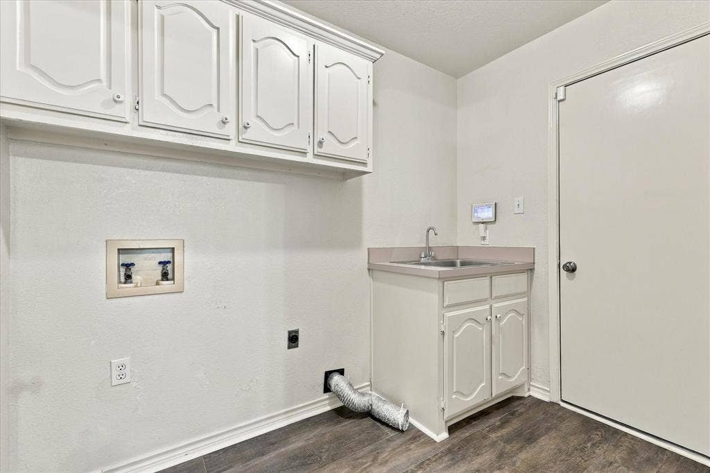 210 Santa Fe Trail, Waxahachie, TX 75165 Utility room featuring white cabinetry, a built-in sink with countertop, and wood-finish flooring