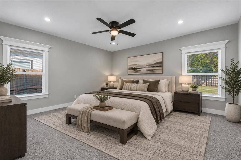 1221 S Rockwall Avenue, Terrell, TX 75160 Neutral wall color, recessed lighting, ceiling fan with integrated light fixture, and windows with prominent millwork trim