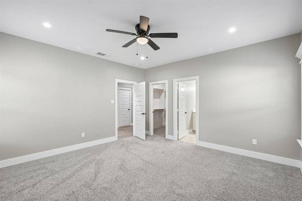1221 S Rockwall Avenue, Terrell, TX 75160 Neutral-toned interior featuring wall-to-wall carpeting, recessed ceiling lighting, and a multi-blade ceiling fan