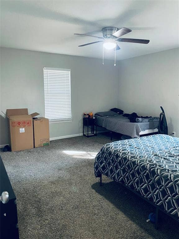 706 E High Street, Terrell, TX 75160 Neutral interior space featuring wall-to-wall carpeting, a single-hung window with horizontal blinds, and a multi-blade ceiling fan with an integrated light fixture