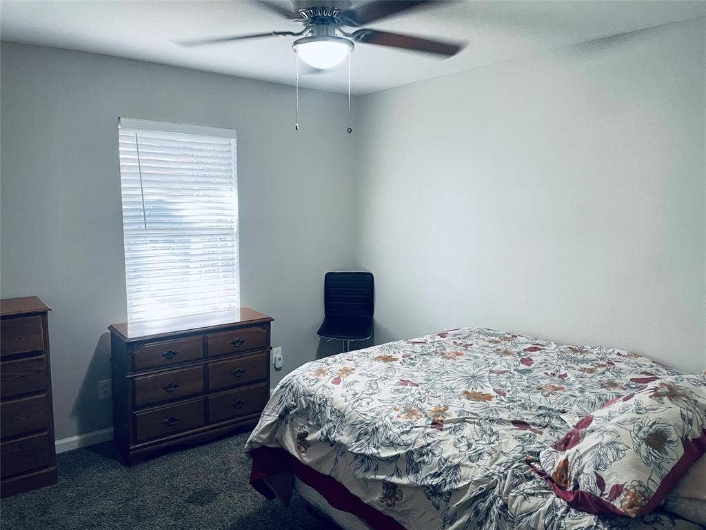 706 E High Street, Terrell, TX 75160 Room featuring neutral-toned walls, carpeting, and a ceiling fan with integrated lighting