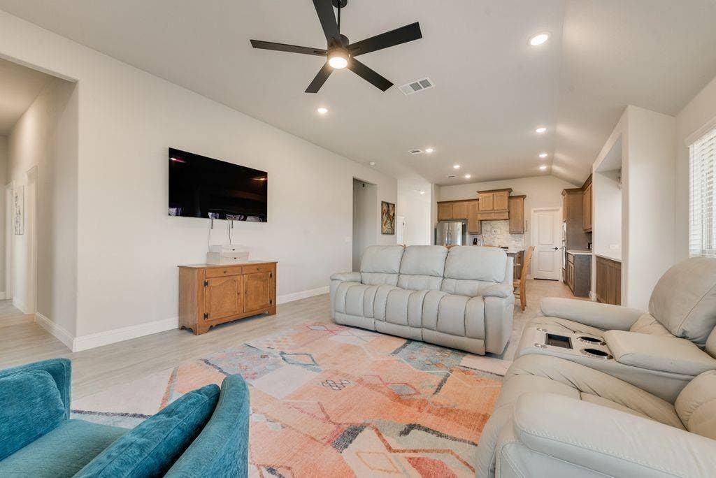 208 Shady Bank Way, Nevada, TX 75173 Vaulted ceilings with recessed lighting, matte black ceiling fan, wood-finish flooring, and neutral wall color