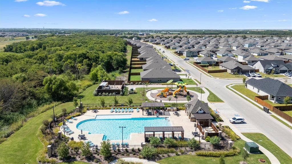208 Shady Bank Way, Nevada, TX 75173 Community amenities featuring an outdoor swimming pool, shaded pavilion structures, and a playground area surrounded by landscaped grounds