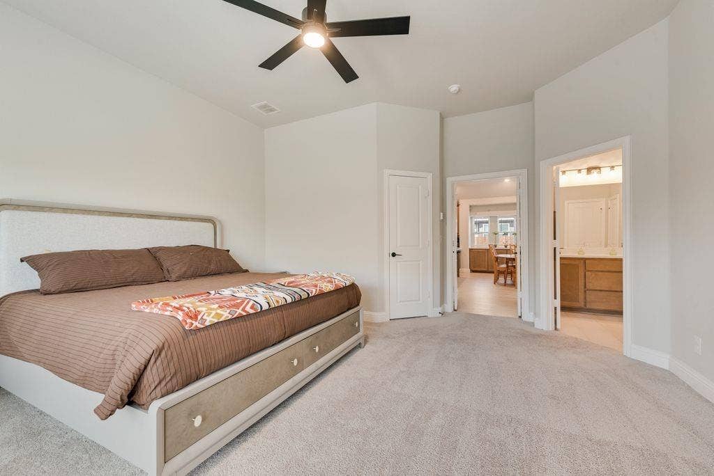 208 Shady Bank Way, Nevada, TX 75173 Neutral-toned interior space featuring high ceilings, wall-to-wall carpeting, and a multi-blade ceiling fan with integrated lighting