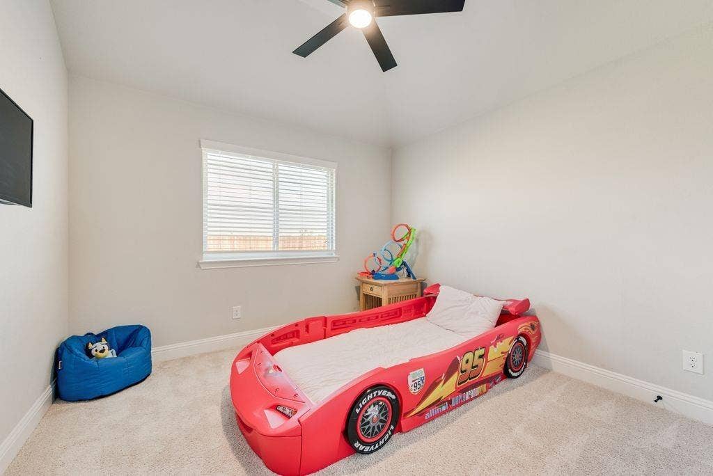 208 Shady Bank Way, Nevada, TX 75173 Neutral interior room featuring neutral-toned carpeting, a window with horizontal blinds, and a matte black ceiling fan