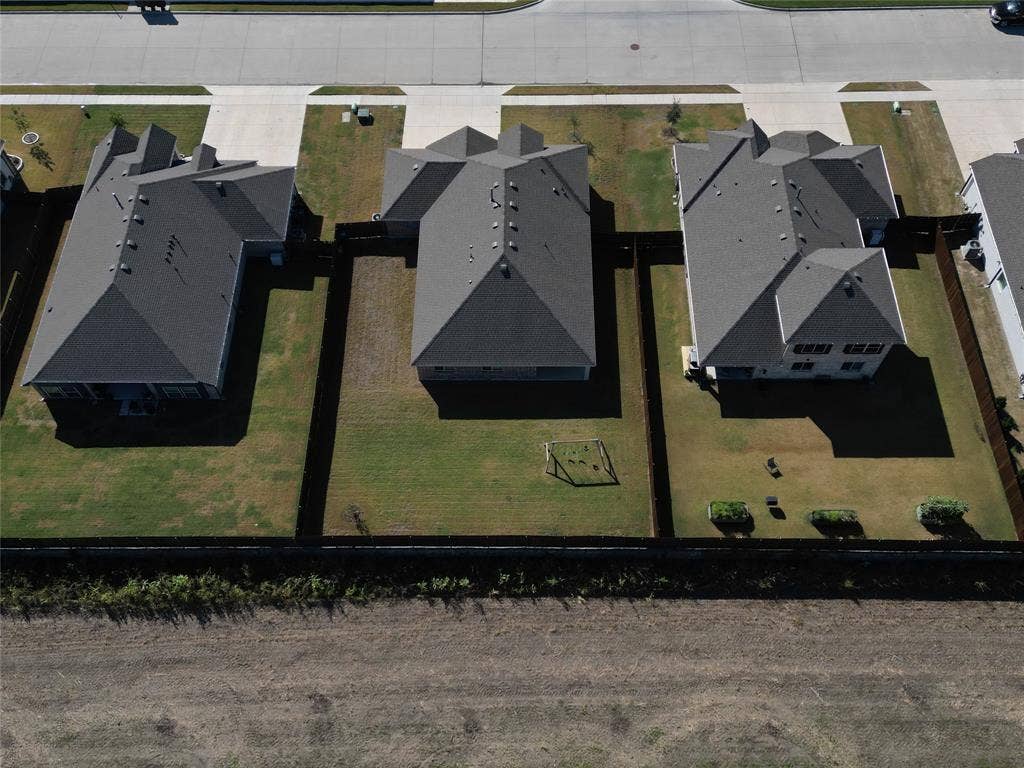 208 Shady Bank Way, Nevada, TX 75173 Aerial view of residential properties featuring hip rooflines, concrete driveways, and fenced rear yards