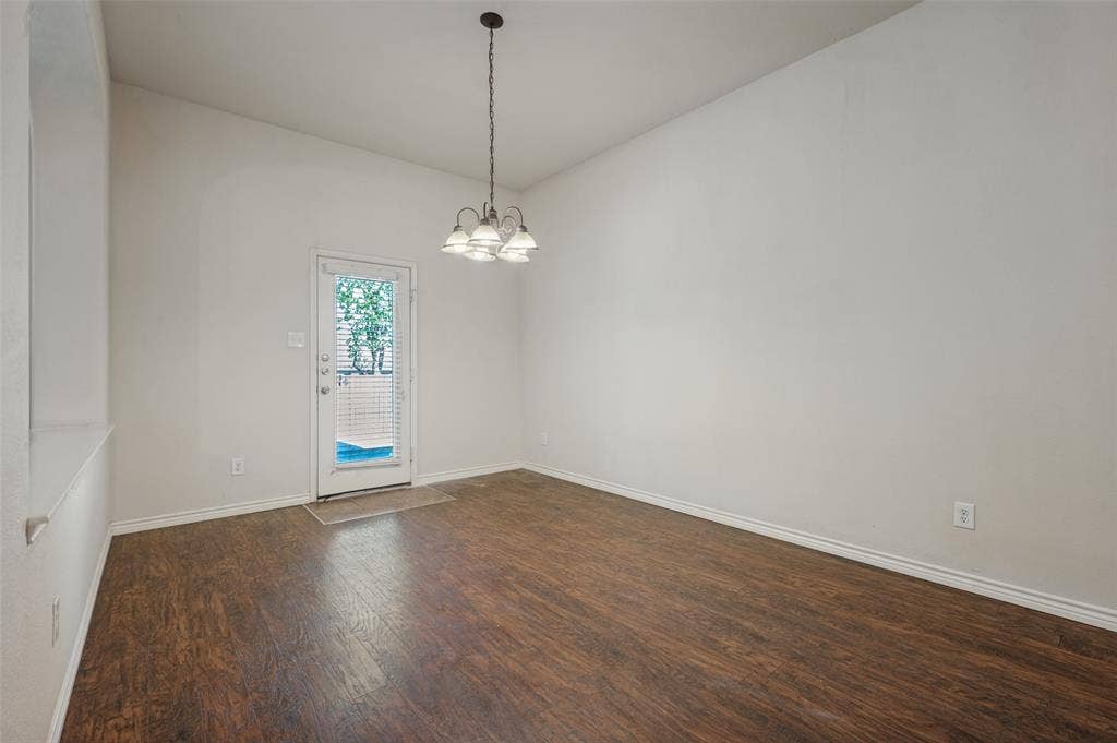 1021 Cherry Hill Lane, DeSoto, TX 75115 Wood-finish flooring, high ceilings, four-light pendant fixture, and glass-paneled exterior door