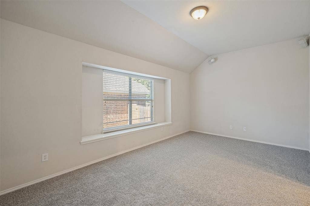 1021 Cherry Hill Lane, DeSoto, TX 75115 Vaulted ceilings, neutral wall color, carpeted flooring, and a recessed window with a built-in sill