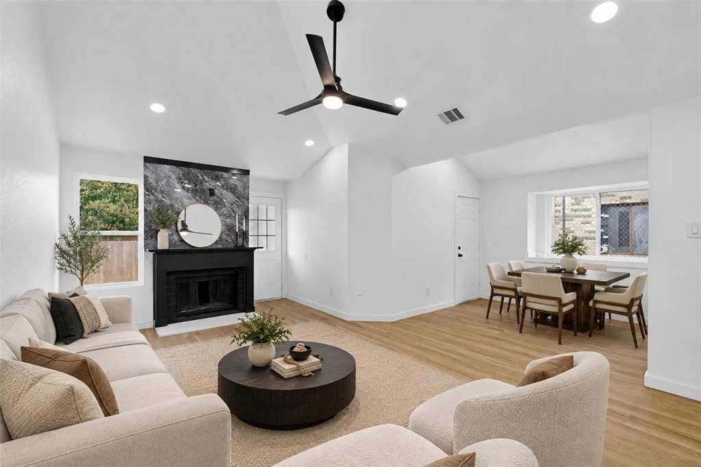 Vaulted ceilings, wood-finish flooring, and recessed lighting throughout