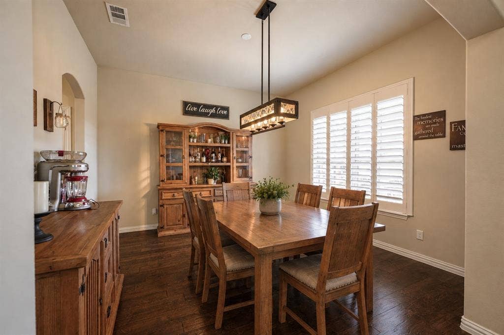 2828 Luke Drive, Farmersville, TX 75442 Wood-finish flooring, plantation shutters, and a rectangular multi-light pendant fixture