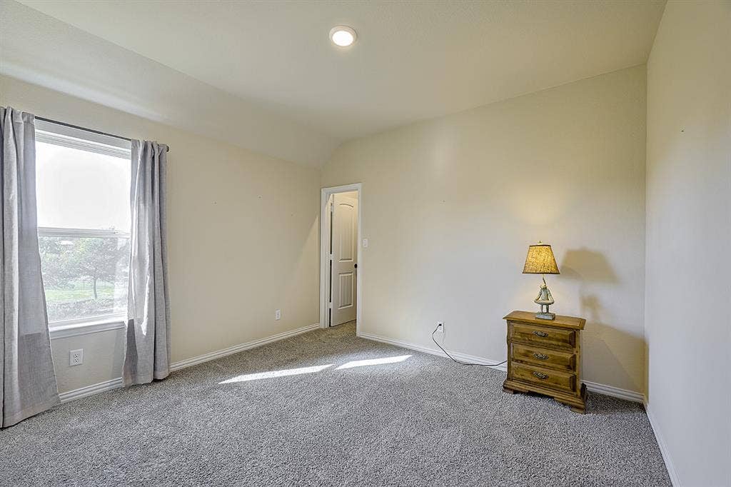 2828 Luke Drive, Farmersville, TX 75442 Neutral-toned interior space featuring neutral wall paint, recessed lighting, carpeted flooring, a single window, and a multi-panel door