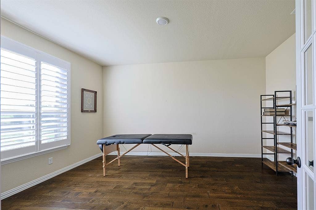 2828 Luke Drive, Farmersville, TX 75442 Interior room featuring dark wood-finish flooring, white plantation shutters, and glass-paneled French doors