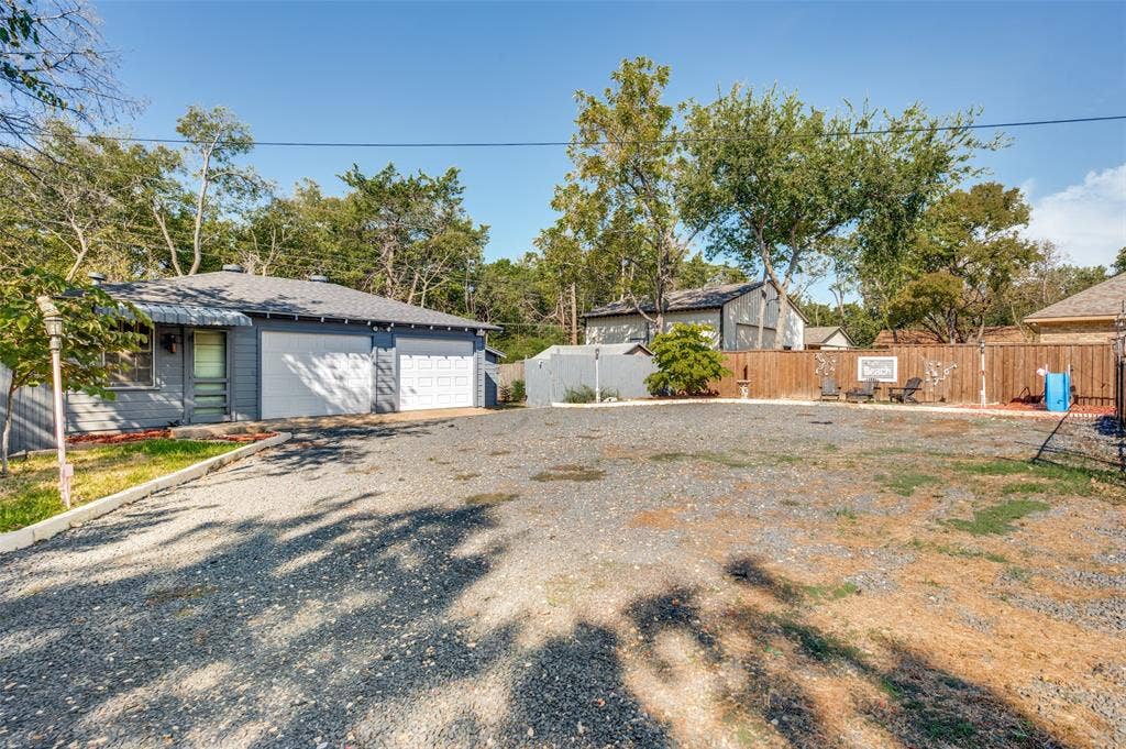5307 Moneta Lane, Dallas, TX 75236 Tons of usable space at the rear of the property, including a detached 2-car garage, multiple storage buildings, and an enclosed 21x9 space that could be used for an office or workout room. It has a half bathroom that needs remodeling.