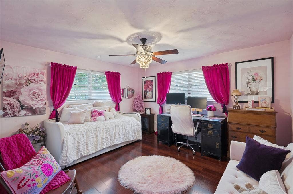 5307 Moneta Lane, Dallas, TX 75236 The second bedroom is at the rear of the house and offers laminate wood flooring, a chandelier fan, and an en-suite powder bathroom.