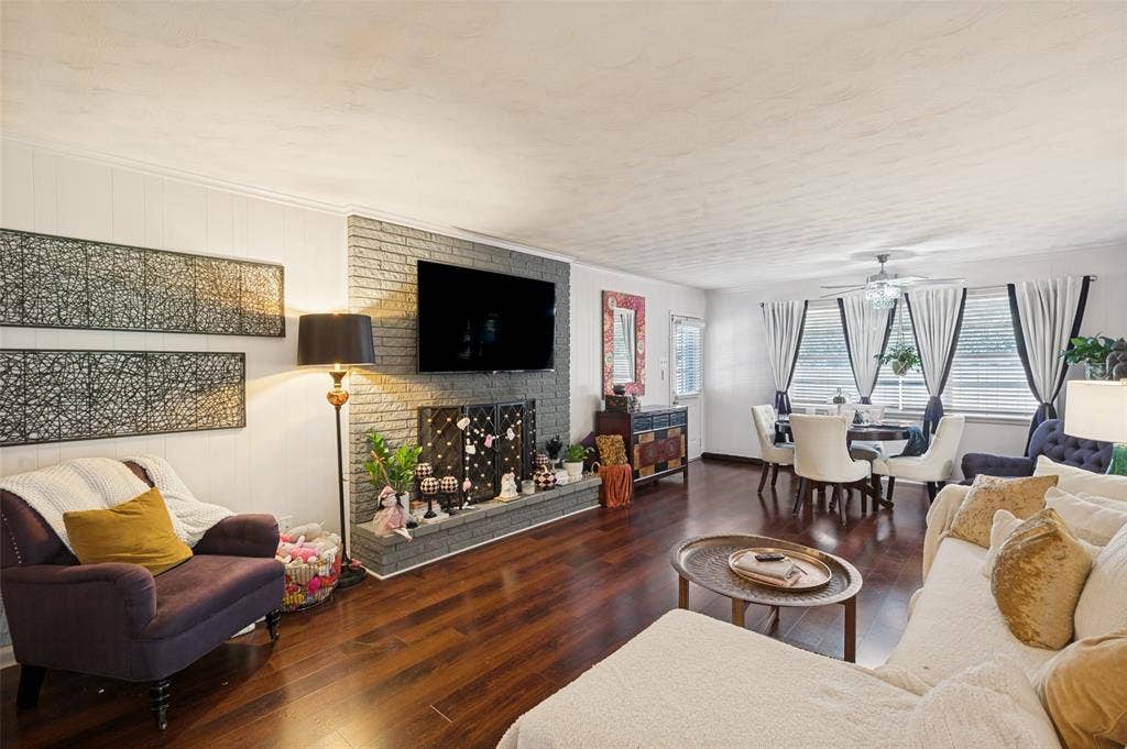 5307 Moneta Lane, Dallas, TX 75236 The heart of the home is the cozy living room with fireplace, adjacent to the dining space.