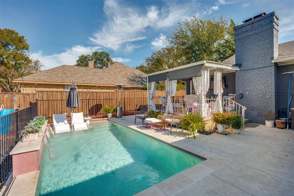 5307 Moneta Lane, Dallas, TX 75236 A beautiful waterfall complements the private pool with huge surrounding patio.