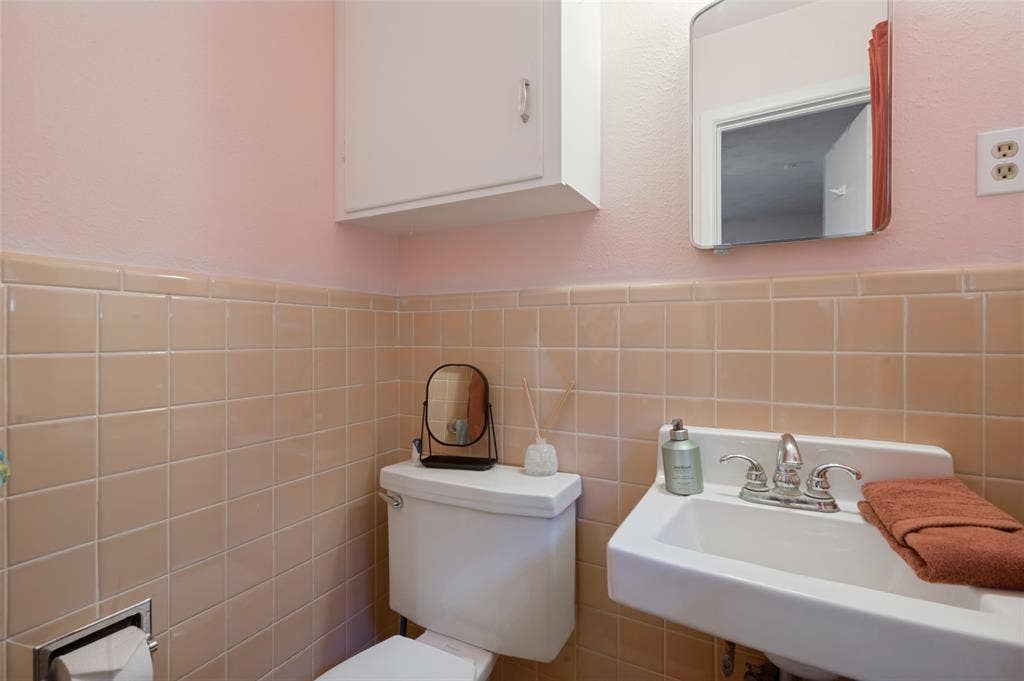 5307 Moneta Lane, Dallas, TX 75236 This half bathroom is connected to the rear bedroom.