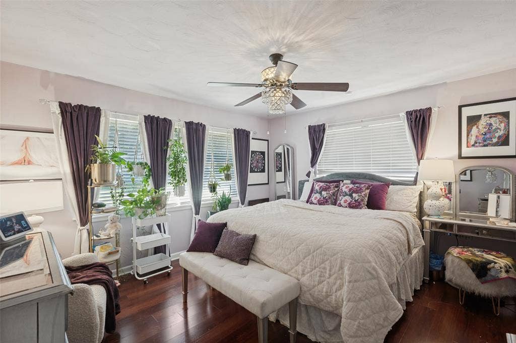 5307 Moneta Lane, Dallas, TX 75236 Either of the bedrooms could serve as the primary. This one is at the front of the house and has great natural light, laminate wood flooring, and a chandelier fan.