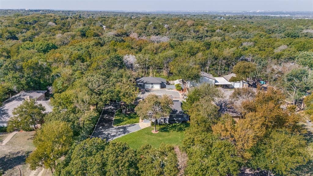 5307 Moneta Lane, Dallas, TX 75236 View from the front showing the great trees and privacy enjoyed by this property.