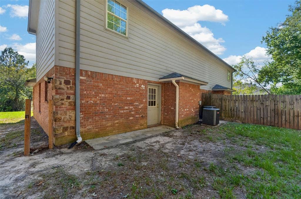 1708 Timber View Drive, Tyler, TX 75703 Exterior featuring a combination of brick and horizontal siding, a private backyard, and a wooden privacy fence