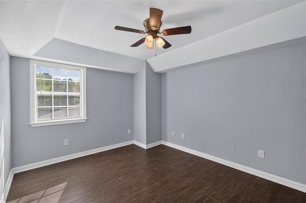 1708 Timber View Drive, Tyler, TX 75703 Tray ceiling, wood-finish flooring, and a multi-light ceiling fan