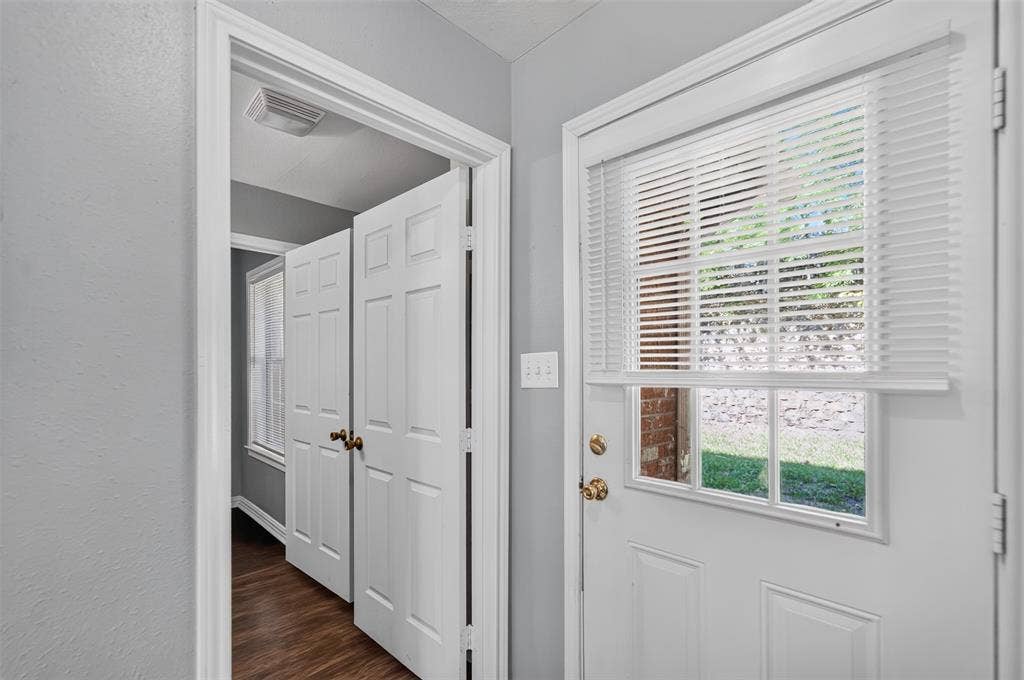 1708 Timber View Drive, Tyler, TX 75703 Entryway featuring wood-finish flooring, white paneled doors, and a door with an inset glass window and integrated blinds