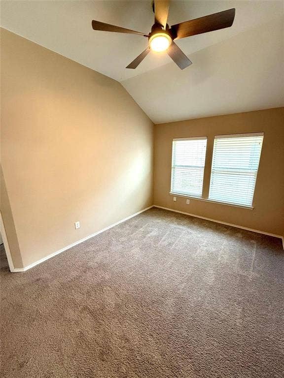 2111 Red River Road, Forney, TX 75126 Room with vaulted ceilings, carpeting, dual windows with horizontal blinds, and an integrated ceiling fan with light fixture